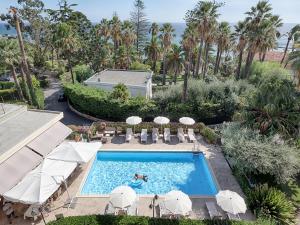 a swimming pool with a pool table and chairs at Hotel Paradiso in Sanremo