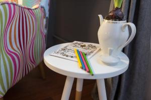 a white table with a vase and some markers on it at Apartment Ciglica in Zagreb