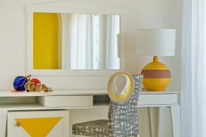 a room with a desk with a mirror and a chair at Relais Maresca Luxury Small Hotel & Terrace Restaurant in Capri