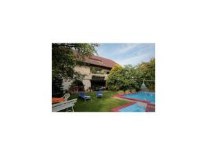 an image of a house with a swimming pool at Gästehaus Meng in Bad Krozingen