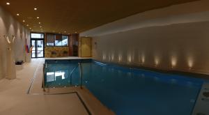 a large swimming pool in a large room at Domitys Terra Souleou in La Valette-du-Var