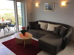 a living room with a couch and a table at Apartmani Marija Klimno A in Klimno