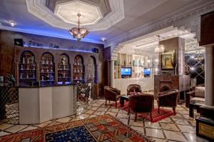a room with a bar with chairs and a table at RIAD DREAMS in Marrakesh