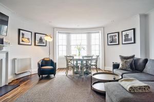 a living room with a couch and a table at ALTIDO Luxury 2 and 3 bed flats on Historic George Street in Edinburgh