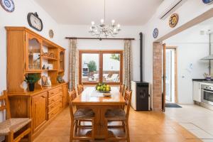 a kitchen with a wooden table and a dining room at CASA SA MARINA en Alcudia in Alcudia