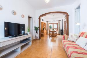 a living room with a couch and a flat screen tv at CASA SA MARINA en Alcudia in Alcudia