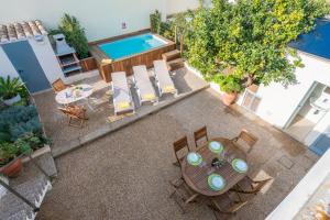 an overhead view of a patio with a table and chairs and a pool at CASA SA MARINA en Alcudia in Alcudia