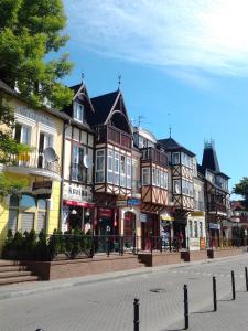 a group of buildings on the side of a street at Pokoje Przy Plaży in Mielno