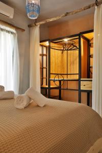 a bedroom with a bed with a towel on it at Villa Melani in Mytilene