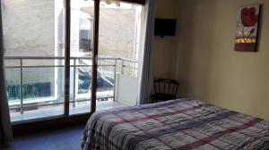 a bedroom with a bed and a view of a balcony at Apartamentos Gladys in Moraira