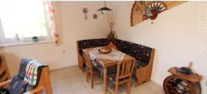 a kitchen with a table and a couch and a table and chairs at House Natalie in Gyenesdiás