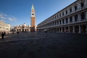 a city square with a clock tower in the distance at San Marco Superior Apartments in Venice