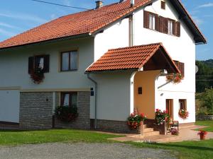 a white house with red roof at Apartments Jure in Smoljanac