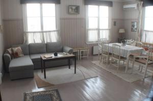 a living room with a couch and a table at Slottsbädden in Ekenäs