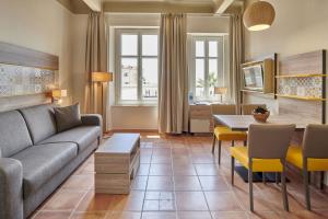 a living room with a couch and a table at Residence Vacances Bleues le Mediterranée in Saint-Raphaël