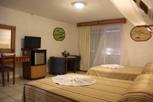 Postelja oz. postelje v sobi nastanitve Hotel Palapa Palace Inn