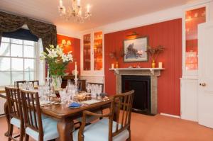 a dining room with a table and a fireplace at Wydemeet Bed and Breakfast in Two Bridges
