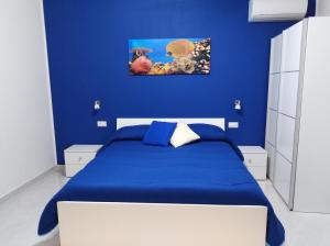 a blue bedroom with a bed with a blue wall at Villa Milena in Agropoli +85 photos