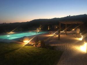 a swimming pool at night with lights on it at Villa Vita in Assisi