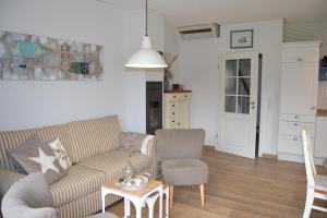 a living room with a couch and a chair and a table at Haus Backbord in Zirchow