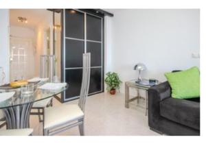 ein Wohnzimmer mit einer Couch und einem Tisch in der Unterkunft Rosa de los Vientos in Málaga