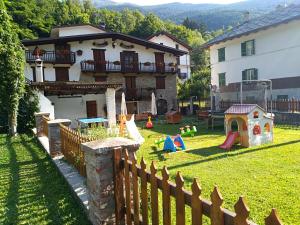 a house with a yard with a playground at Agriturismo Meizoun Blancho in Fenestrelle