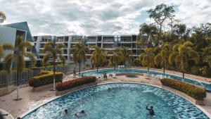 a pool at a resort with people in it at Condominio Terrazas del Sol in Sopetrán