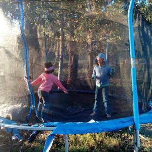 Dos niños están jugando en un trampolín en Hotel Altocerro en Constanza