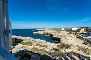 a view of the ocean from a building at Apartamentos Sol Ponent in Cala Blanca