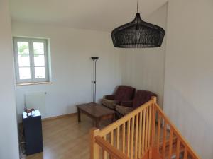 a living room with a couch and a table at La Ferme des Buis in Mercurol