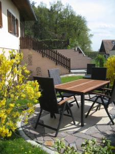 a wooden table and chairs on a patio at Ferienwohnung-Hajek in Sankt Ruprecht an der Raab