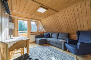 a living room with a couch and two chairs at Willa Pod Giewontem in Zakopane