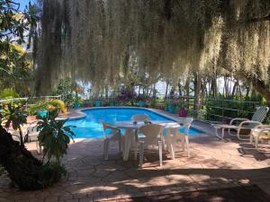 a patio with a table and chairs next to a pool at Case Cassia in Riambel +15 photos
