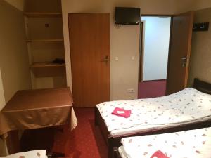 a small room with two beds and a table at Kamionki in Sosnowiec +46 photos