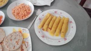 uma mesa coberta com pratos de comida com arroz e pão em Mango Roots em Gampaha mais 63 fotografias