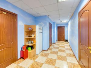 a kitchen with blue walls and a white refrigerator at Отель Турист на Саратовской in Moscow
