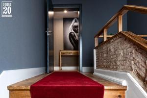 escalera con alfombra roja y escalera en Porta 20 Boutique Guesthouse, en Leiria