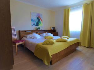 a bedroom with a large bed and a window at Haus Thon in Bodensdorf