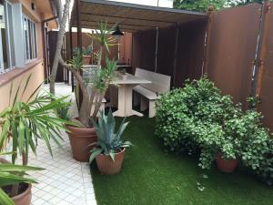 a patio with a table and potted plants at FdM Stay 1 in Forte dei Marmi
