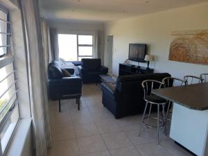 a living room with a couch and a table at SEA4EVER in Port Shepstone