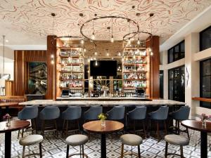a bar in a restaurant with chairs and tables at Sophy Hyde Park in Chicago