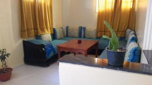 - un salon avec un canapé et une table dans l'établissement Blue Waves apartment, à Agadir