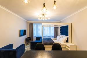 a bedroom with a bed and a table and chairs at Fabulous apartment in heart of Katowice in Katowice