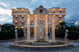 a building with a fountain in front of it at Grand Hotel Osman & Spa e Ristorante il Danubio in Atena Lucana