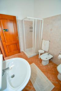 a bathroom with a white sink and a toilet at Agriturismo Sardo in Campavaglio