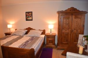 a bedroom with a bed and two lamps on tables at Hotel Bürgergesellschaft in Betzdorf