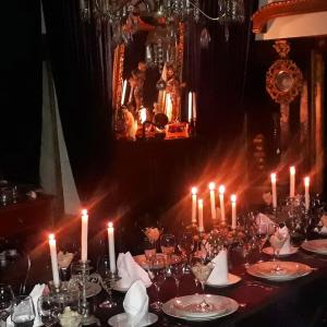 a long table with candles and plates on it at A Hotel Boutique Pelluhue in Pelluhue