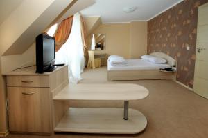 a small room with two beds and a television at Family Hotel Diana in Sofia