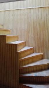 a set of wooden stairs in a building at Tres de junio in Puerto Montt +1 photo