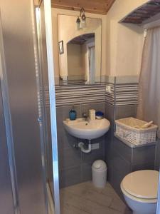 a bathroom with a sink and a toilet and a mirror at Mansarda 5 terre in Monterosso al Mare